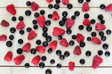 raspberry and black currant on wooden table