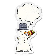 cartoon christmas snowman and thought bubble as a distressed worn sticker