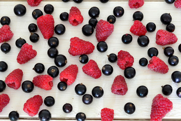 raspberry and black currant on wooden table