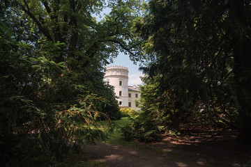 Fototapeta na wymiar View through trees on a late-renaissance castle in Krasiczyn, Poland.