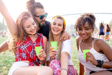 Group of friends having fun at summer music festival