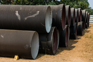 side view of ductile iron pipes stored in open space store yard.