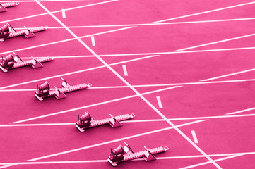 Starting blocks in track and field. Pink color filter