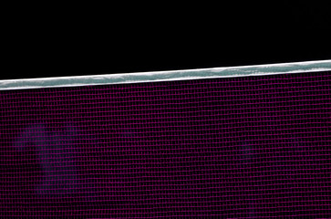 Badminton net indoor on badminton court, closeup view of badminton net with black background