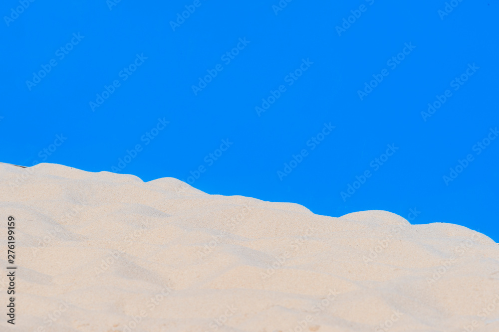 Wall mural football, volleyball, handball summer sport. sandy beach on blue background with copy space for text