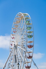 Ferris Mill, big  wheel on a background of blue sky.