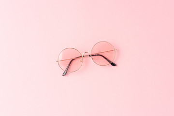 Women’s sunglasses on pink background