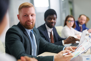 Young confident businessman with paper