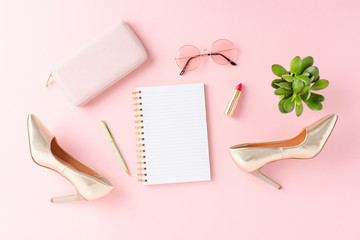 Empty notebook with golden high heels and accessories