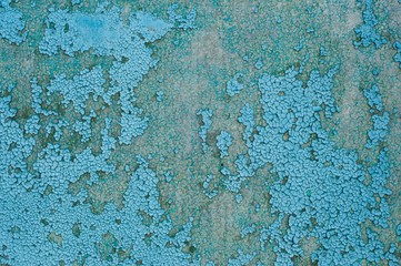 Old cracked blue paint on concrete