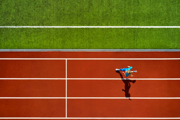 Sportive blonde woman running at open stadium - 276201796