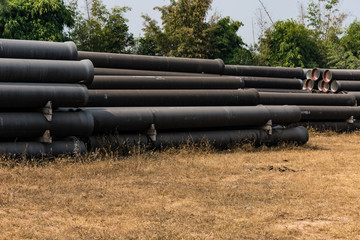 ductile iron pipes stocked in open space of a rural village store yard.