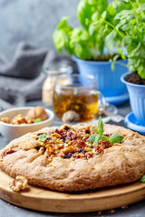 Homemade galette pie with currants and walnuts.