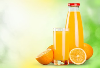 Orange juice glass on background