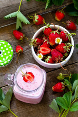 Dietary breakfast for summer time, vegan food concept. Fresh Strawberry milkshake on rustic wooden table.