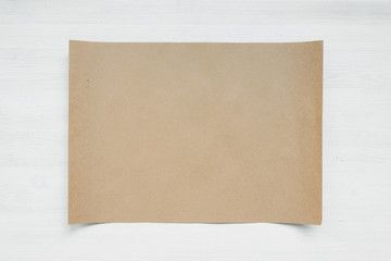 Blank paper page on a white wooden board background. Agreement mockup.