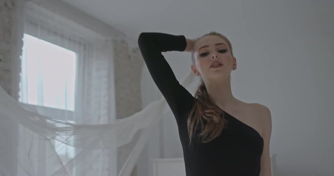 Sensual graceful young woman doing modern dancing, slow motion