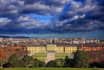 Fototapeta premium View of the Schönbrunn, summer palace of the Habsburgs and the city of Vienna in the background, Austria. Photo taken from the Gloriette pavillon.