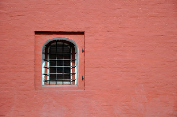 Fototapeta na wymiar Antique brick wall with an arched window. Texture.