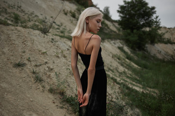 Attractive young woman on the sand. Fashion portrait