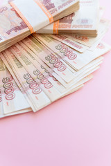 Russian rubles isolated on pink, packed stack of banknotes.Russian money 5000 rubles banknote closeup macro, win concept of russia rouble money.economy, crisis, currency exchange
