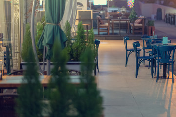 View of empty tables in outdoor cafe on the street european street