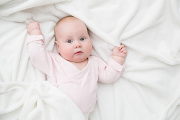 Baby Girl lie in bed, Newborn Child Covered By white Blanket, copy space