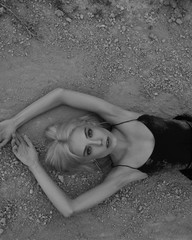 Attractive young woman on the sand. Fashion black and white portrait