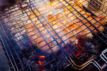Grilled sausage on the picnic flaming grill outdoor