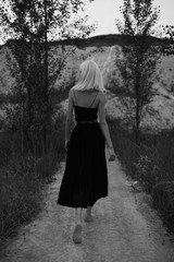 Attractive young woman on the sand. Fashion black and white portrait