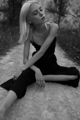 Attractive young woman on the sand. Fashion black and white portrait