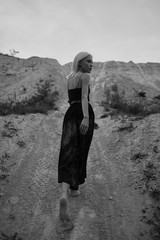Attractive young woman on the sand. Fashion black and white portrait