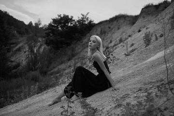 Attractive young woman on the sand. Fashion black and white portrait
