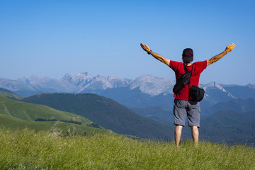 man with arms raised on top of the mountain, mountain range of the Pyrenees