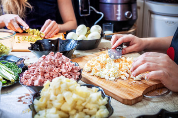 preparing russian salad 'Olivier'