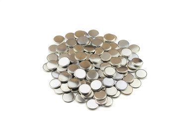 Heap of lithium button cell batteries. Isolated on white background. Closeup.