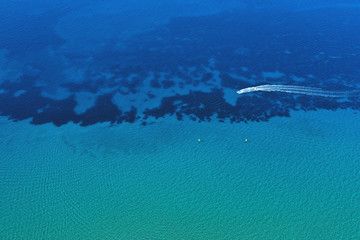 Aerial view of speed boat in motion. Water transportation and summer leisure time activity.