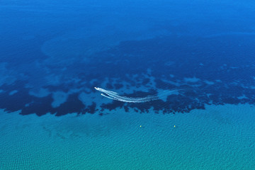 Fototapeta premium Aerial view of speed boat in motion. Water transportation and summer leisure time activity.