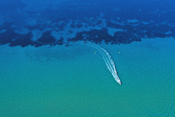 Aerial view of speed boat in motion. Water transportation and summer leisure time activity.