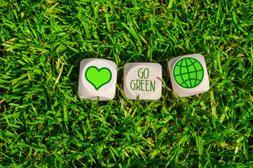Cubes, dice and black chalkboard with Save our planet and go green