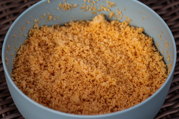 Large bowl with cooked Morocco Couscous mixed with olive oil and paprika powder