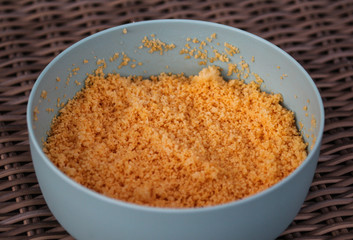 Large bowl with cooked Morocco Couscous mixed with olive oil and paprika powder
