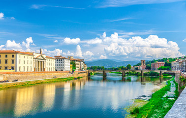 Ponte alle Grazie bridge over Arno River blue reflecting water, PromoFirenze and buildings on embankment promenade in historical centre of Florence city, blue sky white clouds, Tuscany, Italy