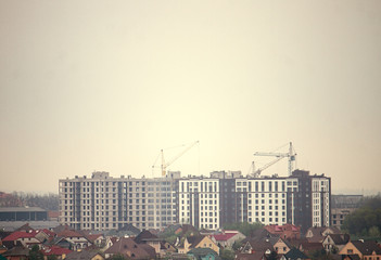 Construction of multi-storey buildings by crane.