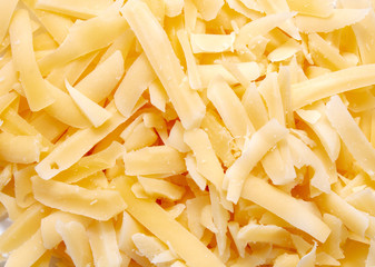 Delicious grated cheese on white background