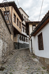 Fototapeta na wymiar View of a narrow street in historical part of Plovdiv Old Town. Typical medieval colorful buildings. Bulgaria
