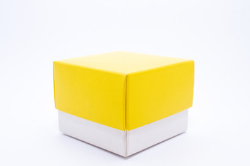 Box with a yellow lid on a white background