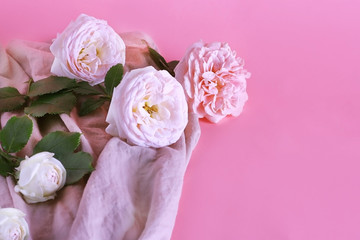 The flowers of the rose are gently pink in color on a sweet lilac pastel background with copy space. The concept of a minimal flower.