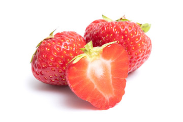 Isolated strawberries. Two whole strawberry fruits and half isolated on white background, with clipping path