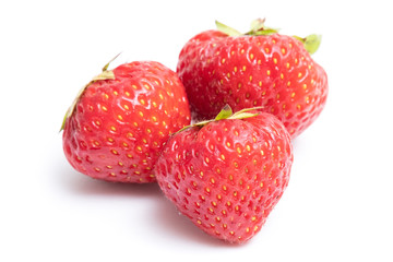 Three fresh strawberries isolated on white background.